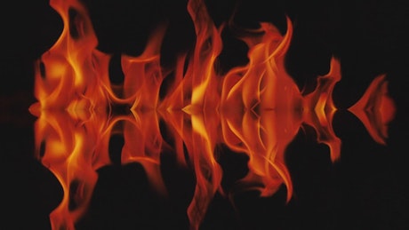 Mirror effect of flames burning on a black background.