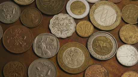 Mix of international coins on the table.