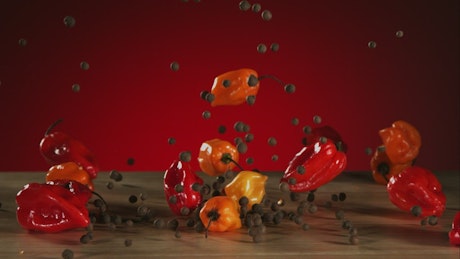 Mix of peppers falling to the table