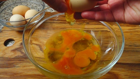 Mixing eggs in a bowl.