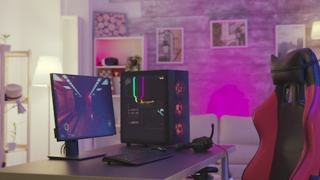Modern pink gaming room with PC and chair.