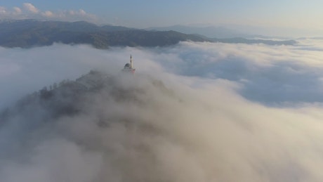 Mosque on a mountain in the morning mist.