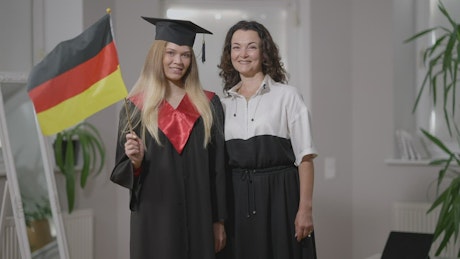 Mother and daughter celebrating at a graduation ceremony.