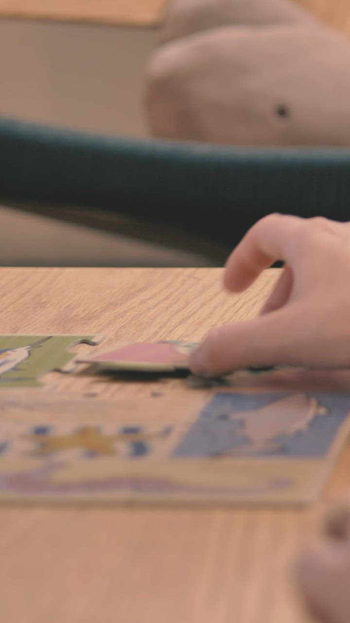 Mother puts together a puzzle with her daughter - Free Stock Video