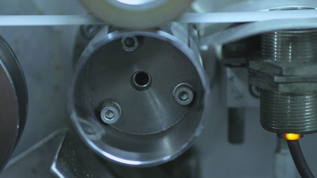 Motor of an industrial machine that moves a belt.