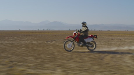 Motorcyclist traveling through the desert.