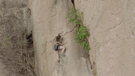 Mountaineer climbing a rocky mountain