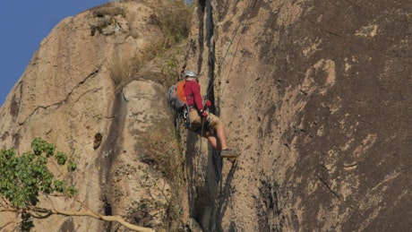 Mountaineer descending a rocky mountain.