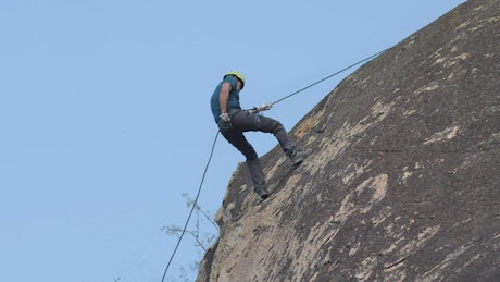 Mountaineer descending from a rocky mountain.