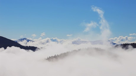 Mountains covered in mist to the top.