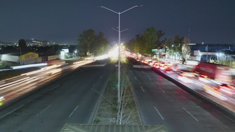 Movement in a large avenue at night in Timelapse.