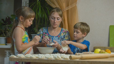 Mum and children make their own cookies.