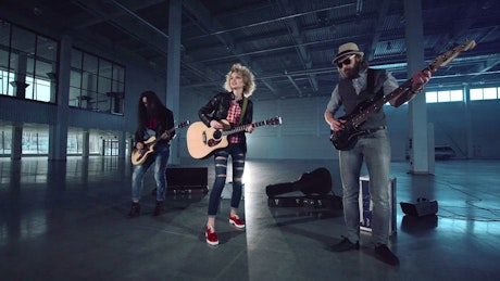 Music band shooting video in an empty warehouse.