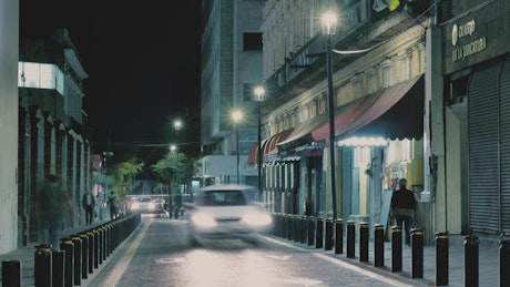 Narrow avenue at night.