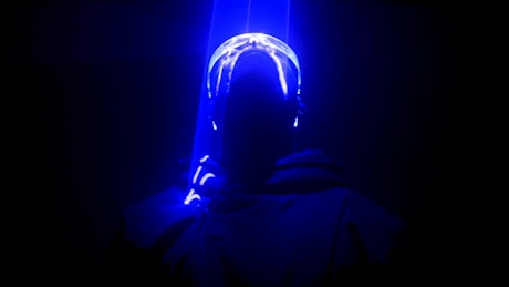 Neon lasers light up a cyberpunk dancer.