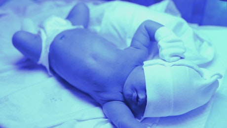 Newborn baby in hospital bed