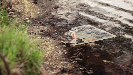 Newspaper abandoned in the water.