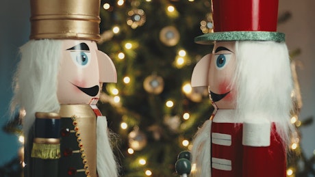Nutcracker Puppets with a Christmas tree in the background.