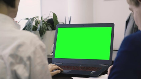 Office laptop with a green screen