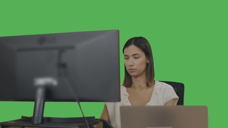 Office woman at her desk on a green background