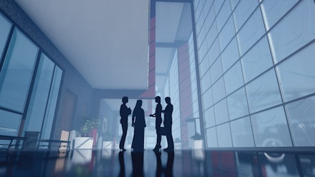 Office workers chatting in an elegant building.