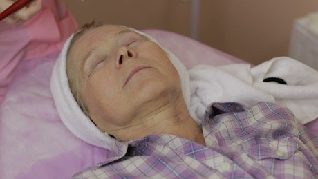 Older woman having a spa treatment.