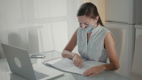 On a digital meeting at home with a face mask