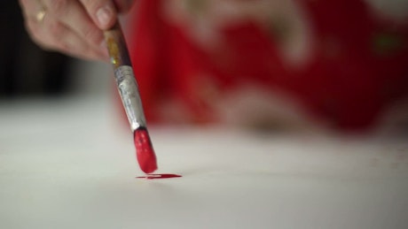 Painting with red paint on paper.