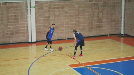 Pair of basketball players playing in training.