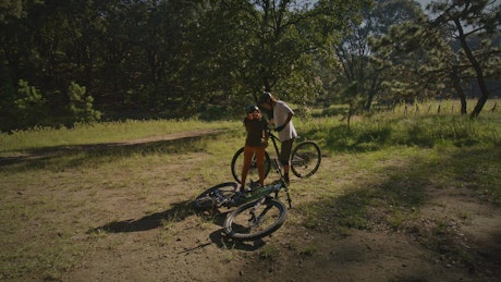 Pair of cyclists getting ready in a forest.