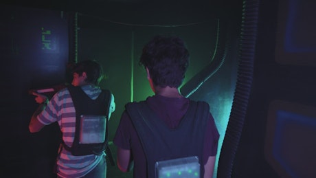 Pair of guys playing laser tag together