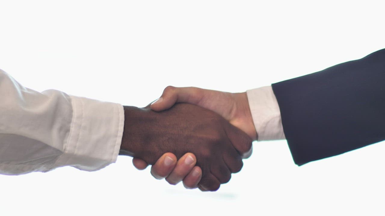 Pair of hands shaking hands on white b 888 login ackground