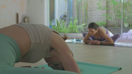 Pair of women doing yoga together.