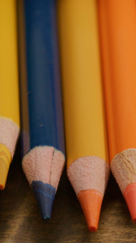 Pan shot of colored pencils on a table.
