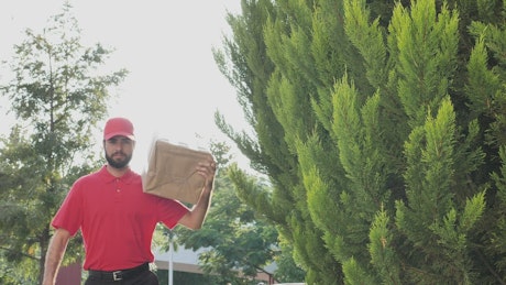 Parcel delivery man making a confident gesture.
