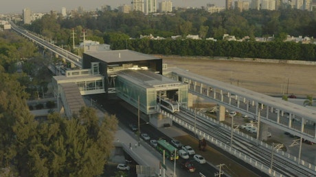 Passenger train leaving a station in an aerial shot