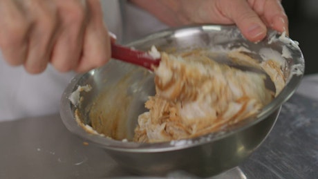 Pastry woman making a mix in a bowl.