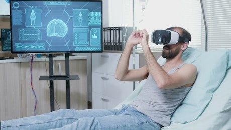 Patient in futuristic hospital uses VR to look at brain.