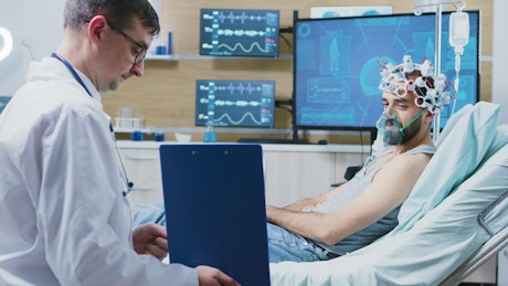 Patient undergoing brain scan chats with doctor