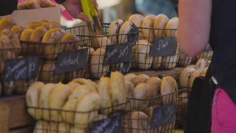 People buying bagels at a market.