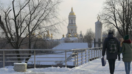 People walking on a snowy bridge