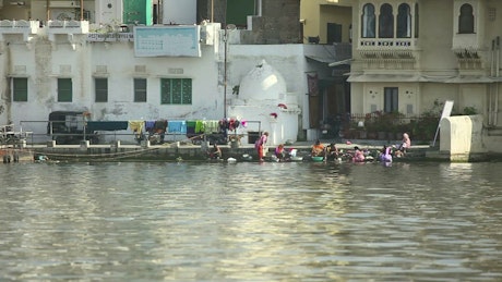 People washing clothes in the river.