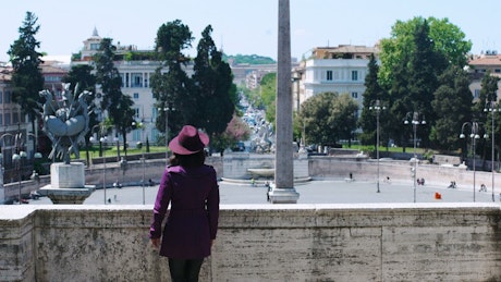 Person in a purple hat taking a photo of the view in Europe.