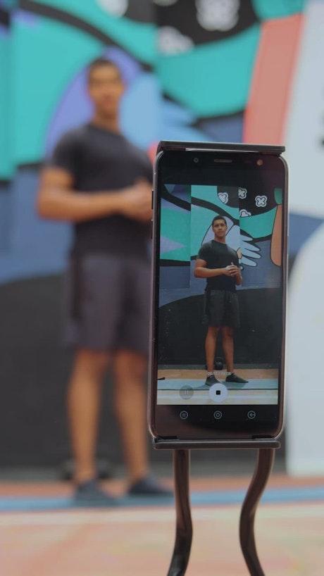 Person is filmed exercising with a cell phone.