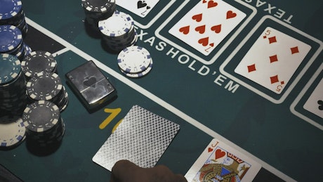 Person playing Texas Hold'em.