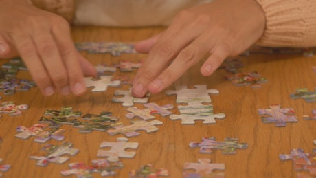 Person putting together a big puzzle.
