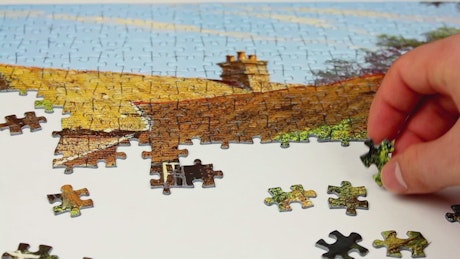 Person putting together a puzzle