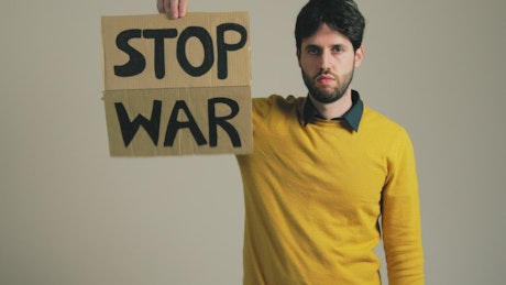 Person raises up a Stop War sign.
