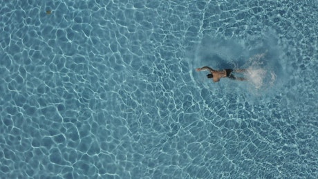 Person swimming in a pool.