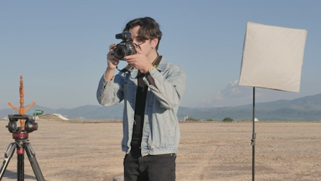 Photographer taking photos in a desert.